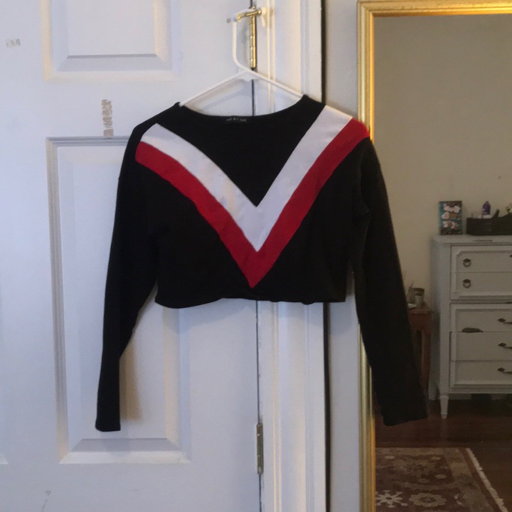 Cropped black long sleeve top.